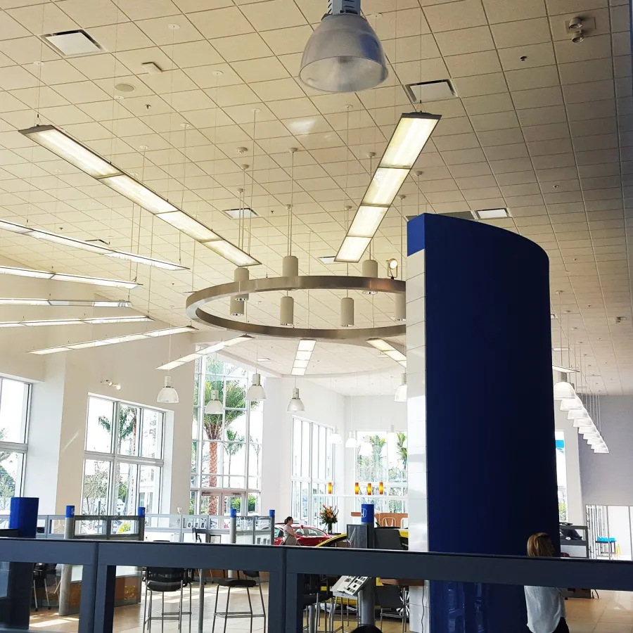 A finished office interior under a ring of pendant lights